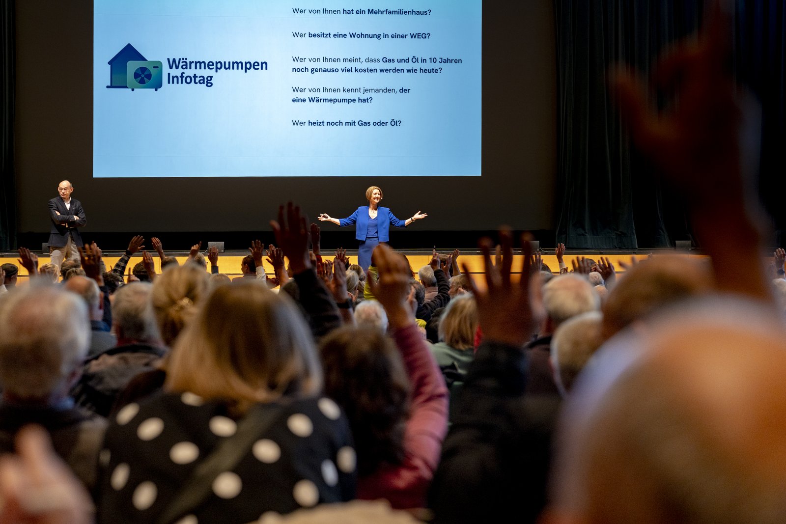 Viele Hände gehen im Publikum hoch, Anja Floetenmeyer-Woltmann fragt den Saal